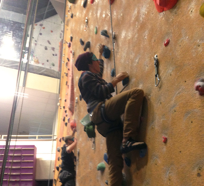 Blindfolded students climbing a wall